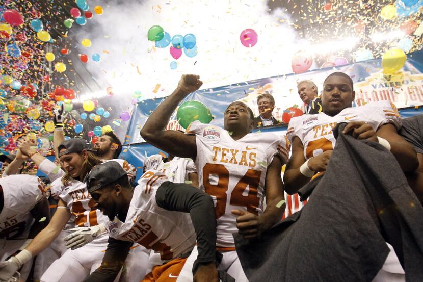 Texas wide receiver Marquise Goodwin (84) and teammates celebrate after defeating Oregon...