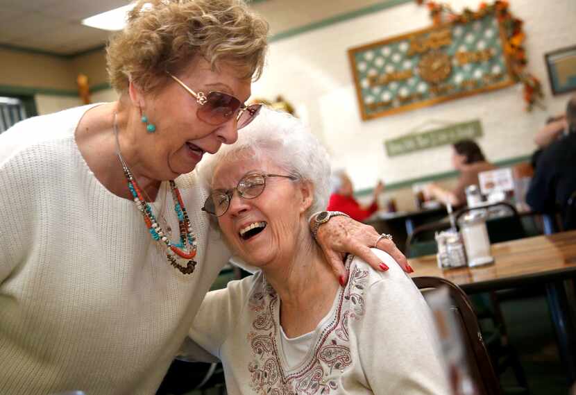 Carol Wood (right), owner of Joe's Coffee Shop, receives a hearty hug from longtime friend...