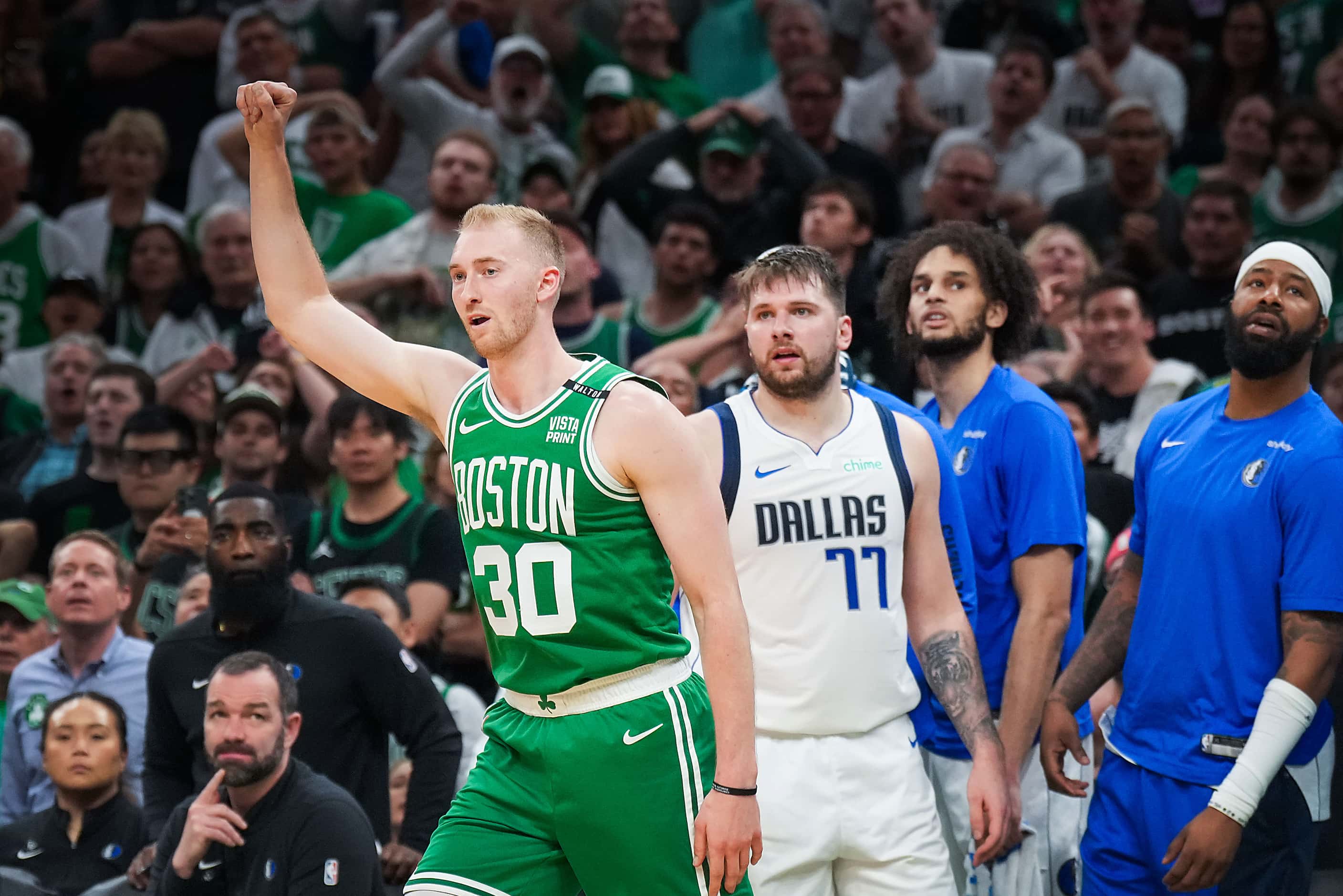 Boston Celtics forward Sam Hauser (30) celebrates after a 3-pointer as Dallas Mavericks...