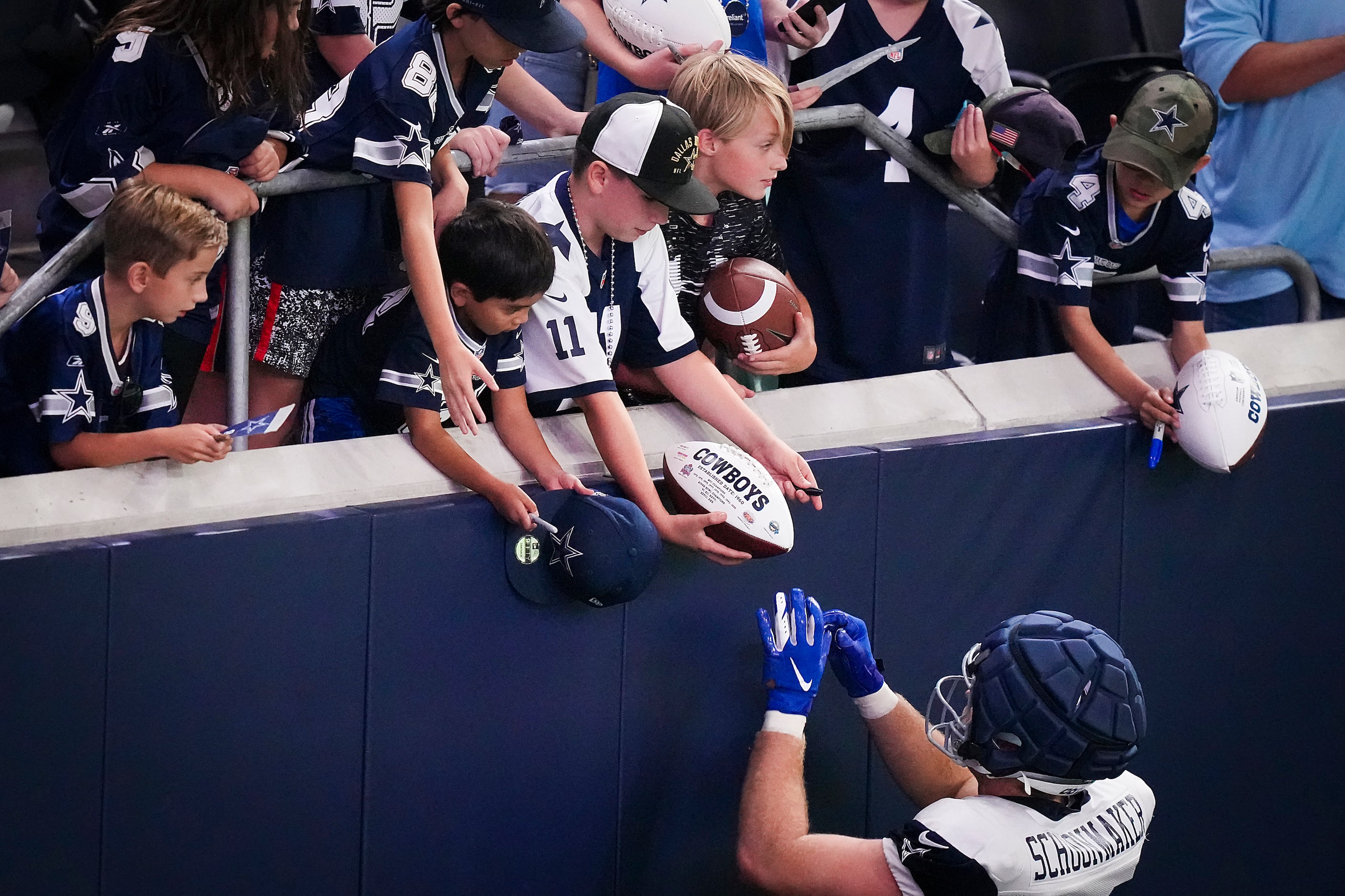 Dallas Cowboys tight end Luke Schoonmaker (86) signs autographs after the team’s first...