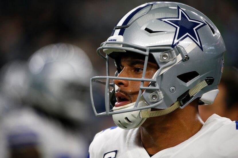 Dallas Cowboys quarterback Dak Prescott warms up before an NFL football game against the...