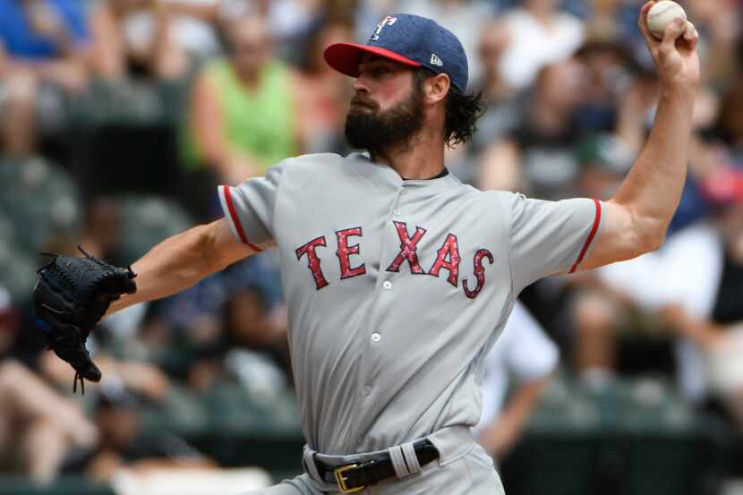 Texas Rangers starting pitcher Cole Hamels throws the ball  during the first inning of a...