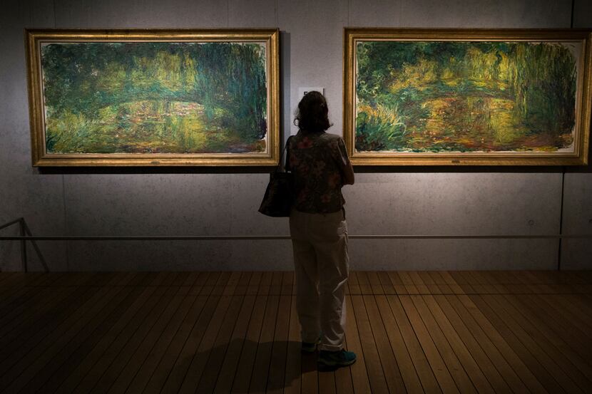 A museum-goer views "The Japanese Bridge" paintings by Claude Monet as part of the Monet:...