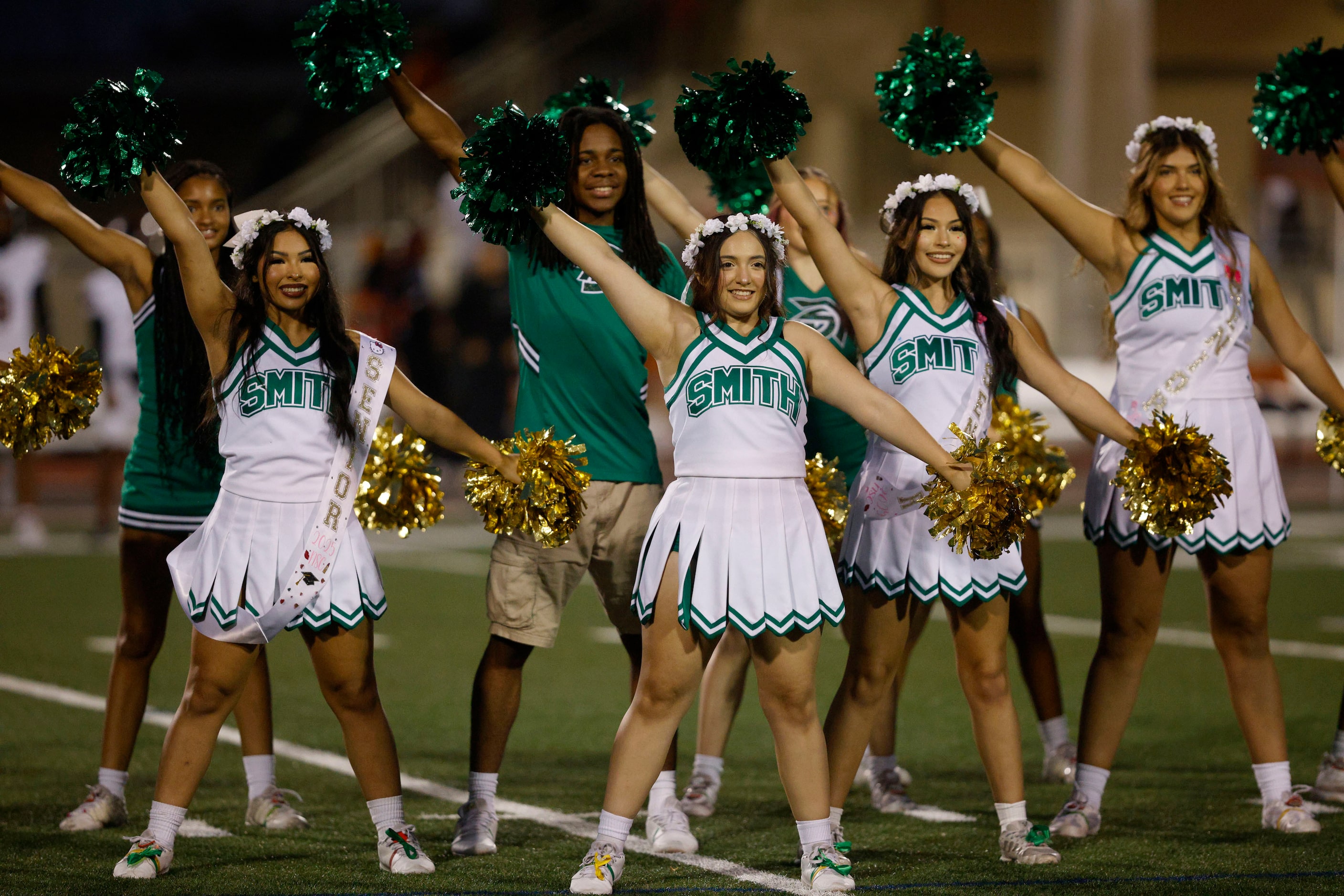 Newman Smith cheerleaders perform before a high school football game against West Mesquite...