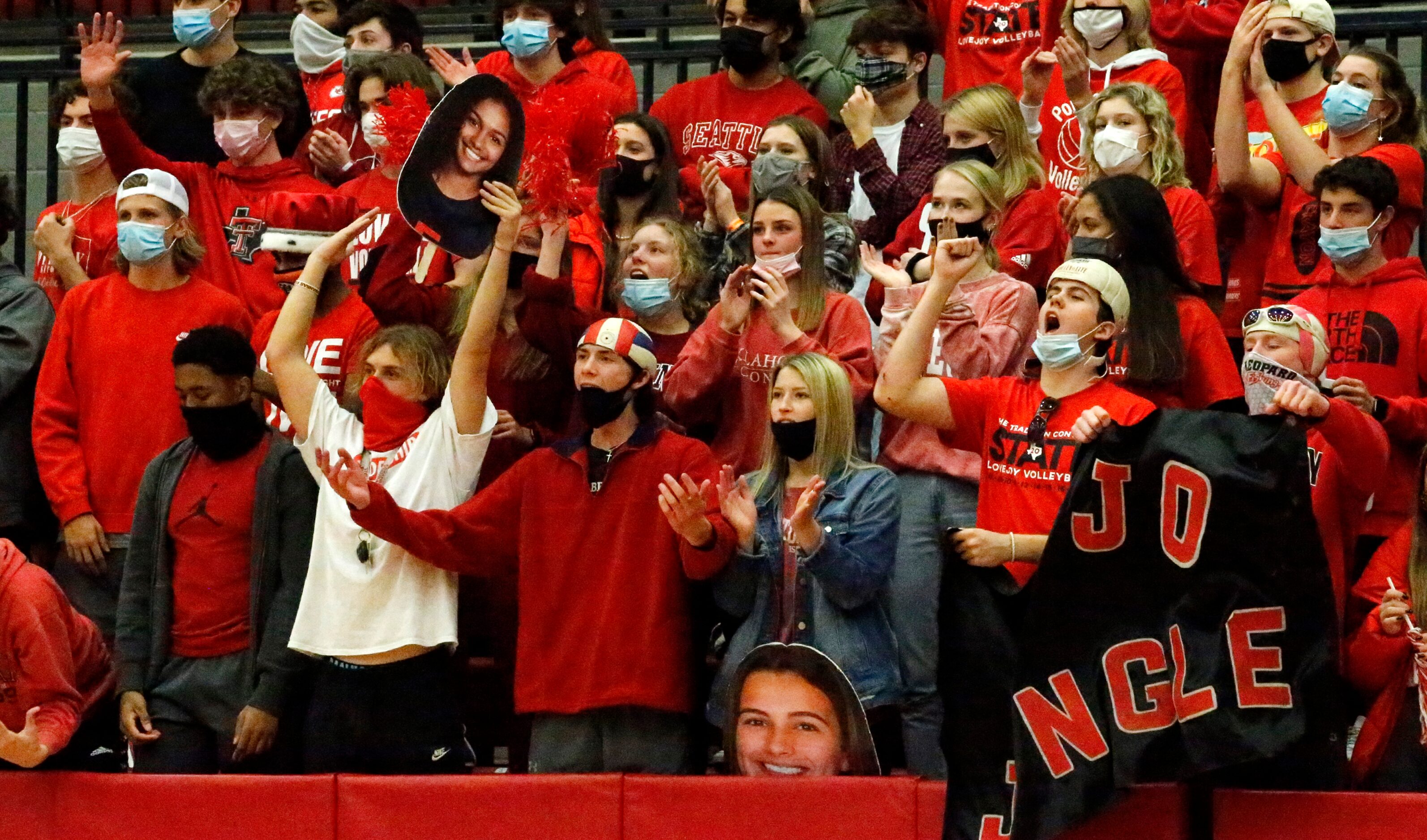 Lovejoy High School students react as their team makes match point during game three as...