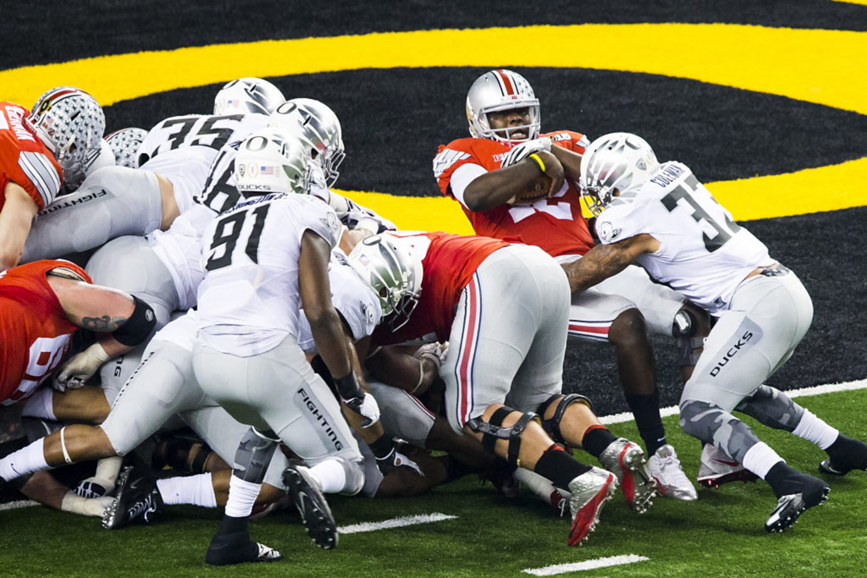 Ohio State Buckeyes quarterback Cardale Jones (12) backs into the end zone through the...