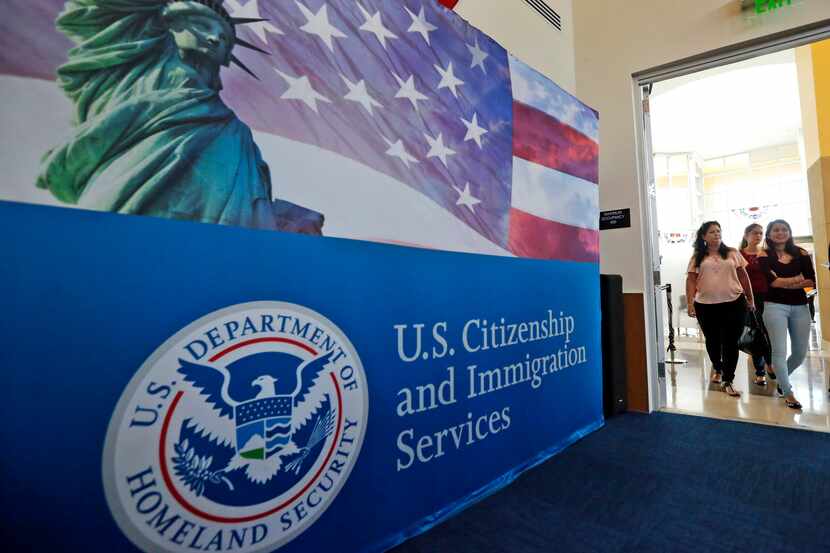 In this Aug. 17, 2018, photo, people arrive before the start of a naturalization ceremony at...