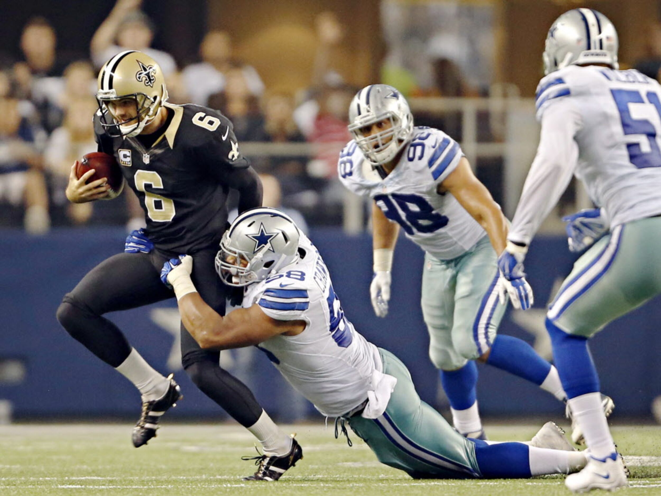 Dallas Cowboys defensive end Jack Crawford (58) tackles New Orleans Saints punter Thomas...