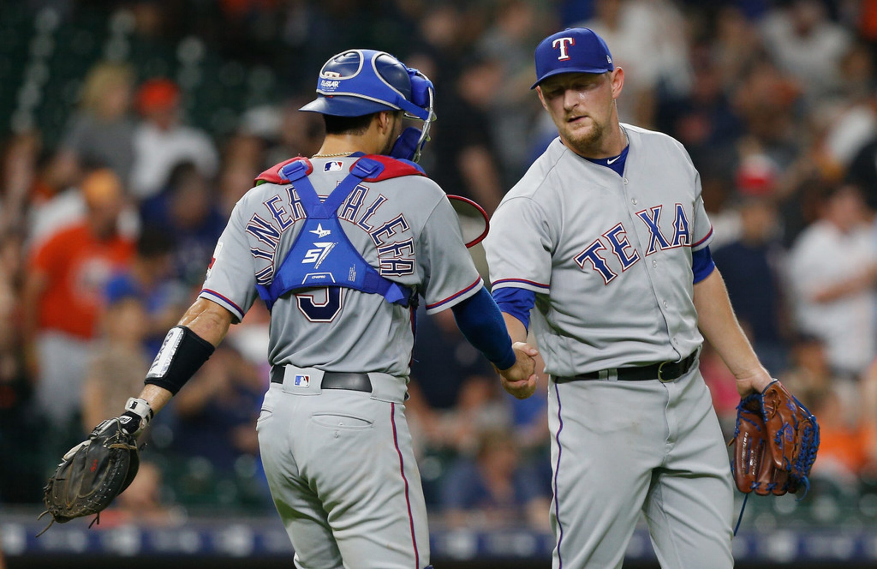 HOUSTON, TX - JULY 28:  Isiah Kiner-Falefa #9 of the Texas Rangers shakes hands with Austin...