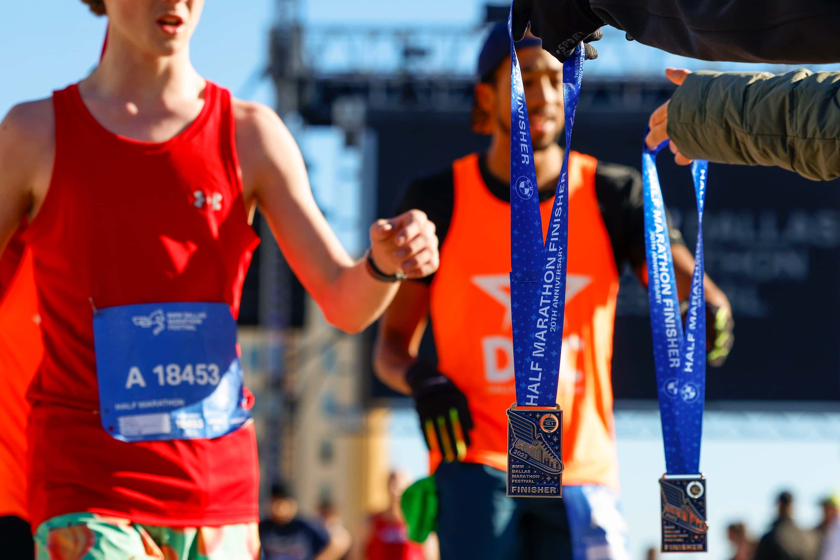Half marathon finishers receives their medals during 2023 BMW Dallas Marathon on, Sunday,...