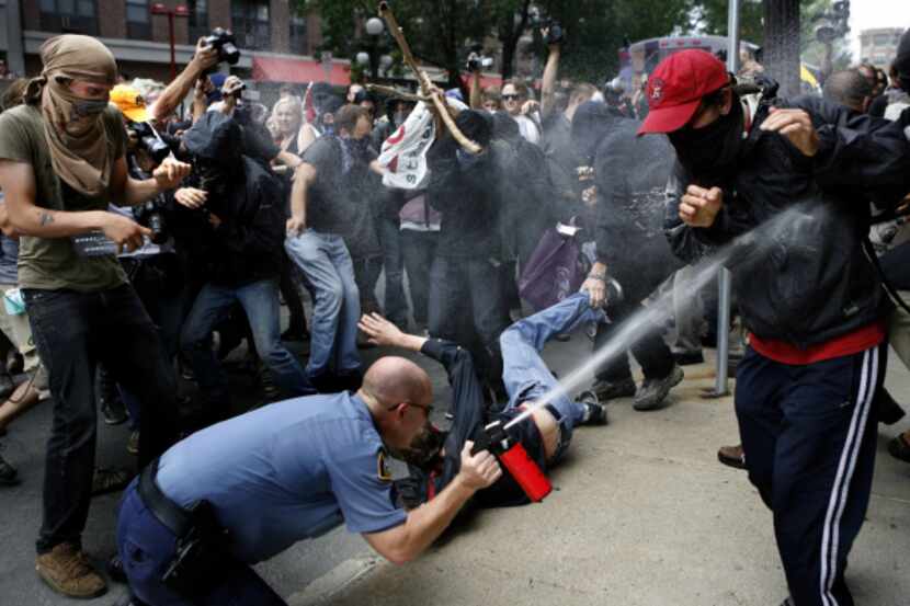 A lone police officer used spray to get away from protesters during the first day of the...