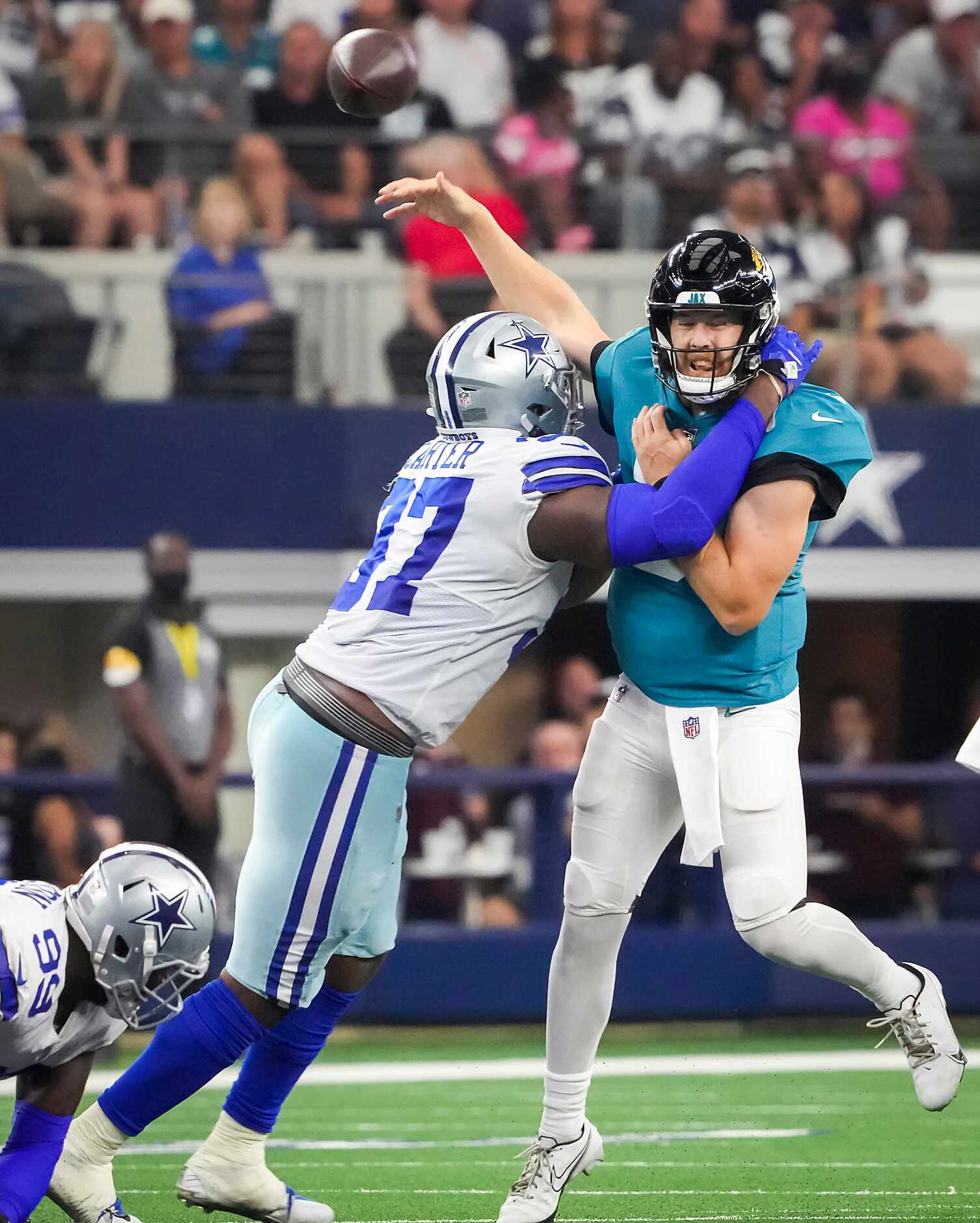 Jacksonville Jaguars quarterback C.J. Beathard (3) throws an interception as he is hit by...