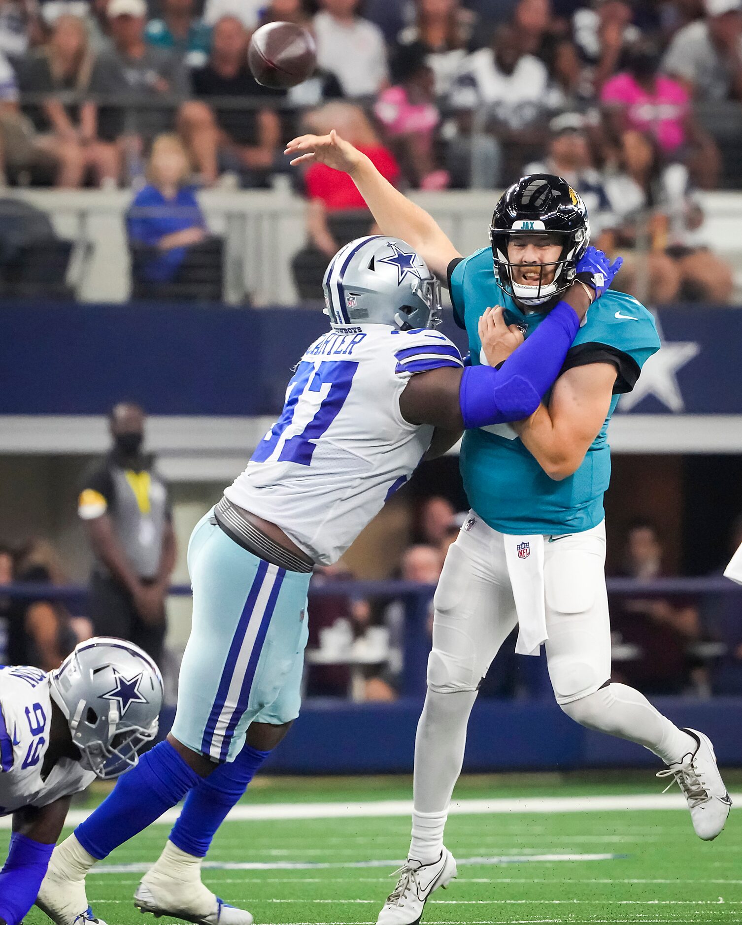 Jacksonville Jaguars quarterback C.J. Beathard (3) throws an interception as he is hit by...