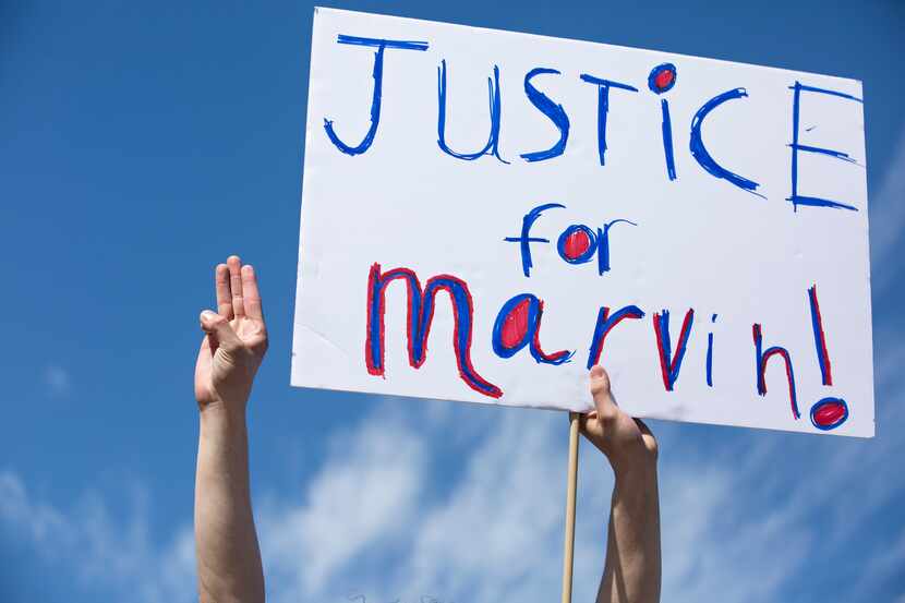 People marched through the Allen Premium Outlets on March 21, demanding justice for Marvin...