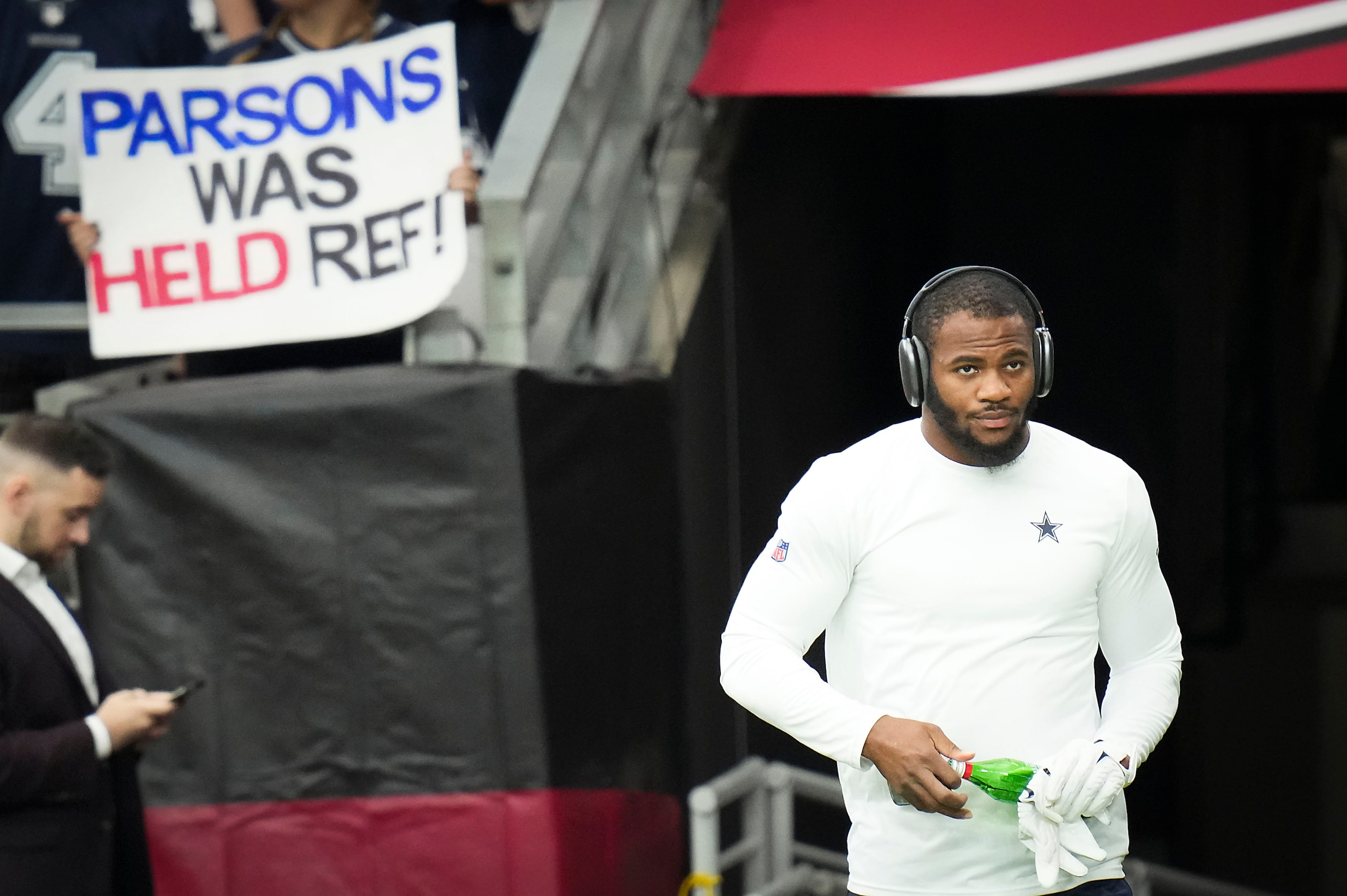 Dallas Cowboys linebacker Micah Parsons takes the field to warm up before an NFL football...