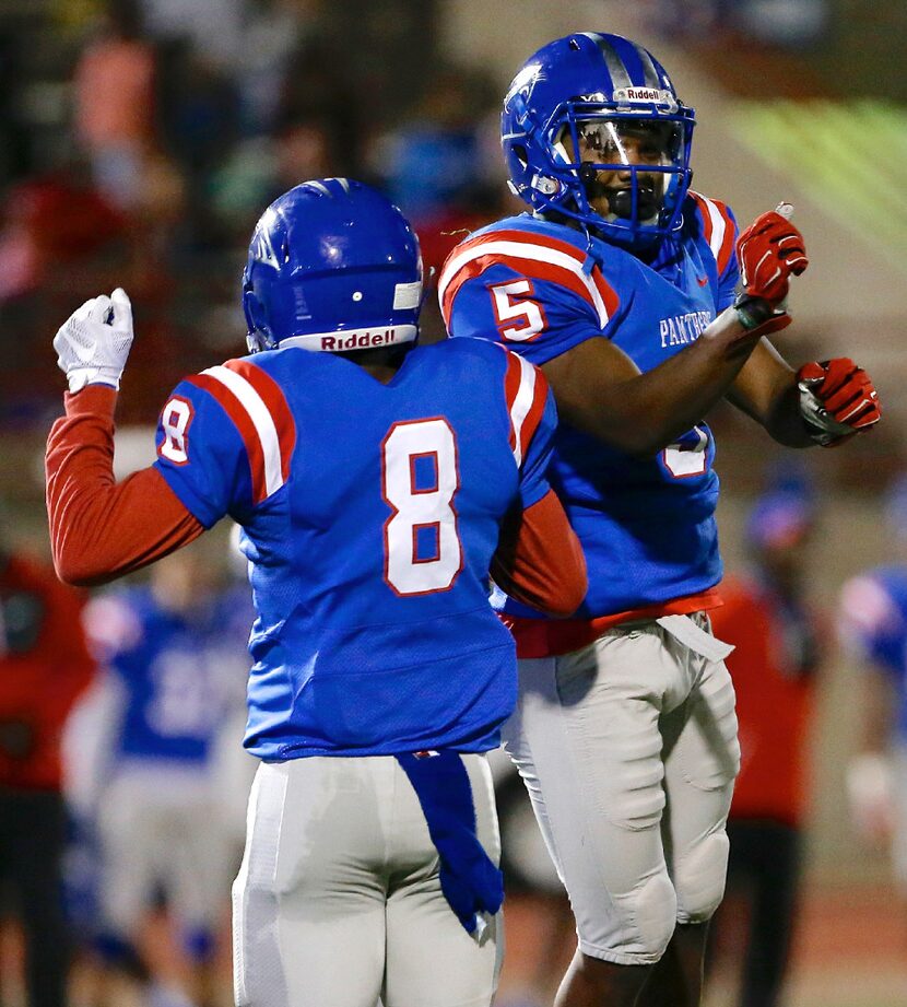 Duncanville senior defensive back Tre Siggers (5) is congratulated by senior defensive back...