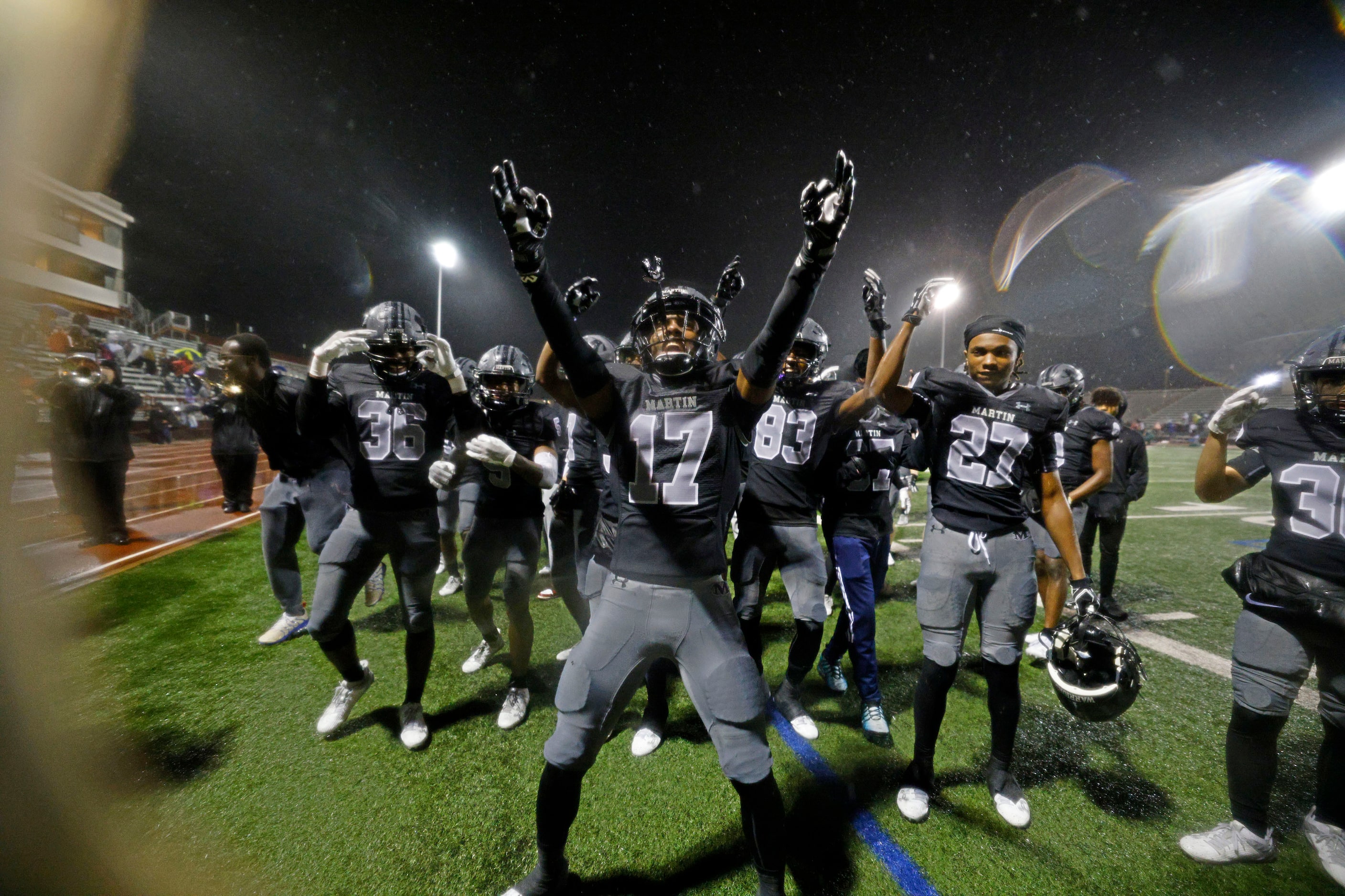 Martin's Zavien Abercrombie (17) and his teammates celebrate their 42-16 victory against...