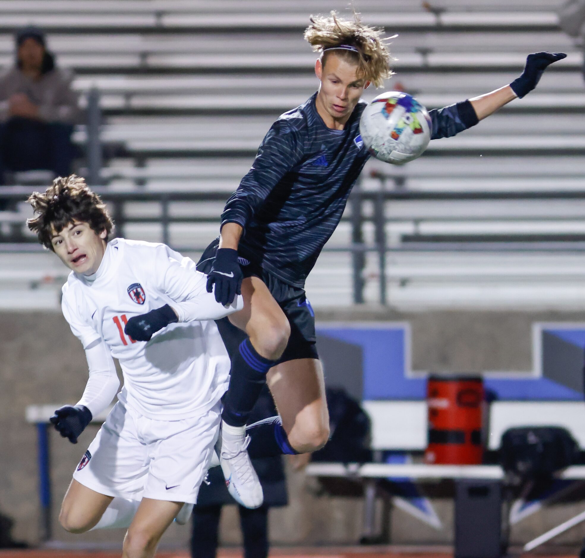 Flower Mound Marcus’ Aidan Henle (11) braces against Hebron’s Aidan Veach (18) as Veach...