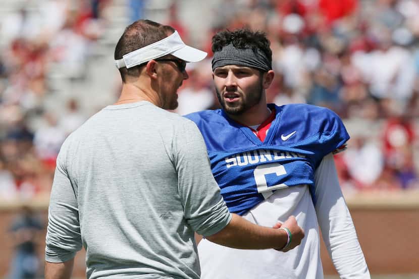 Oklahoma quarterback Baker Mayfield (6) talks with offensive coordinator Lincoln Riley...