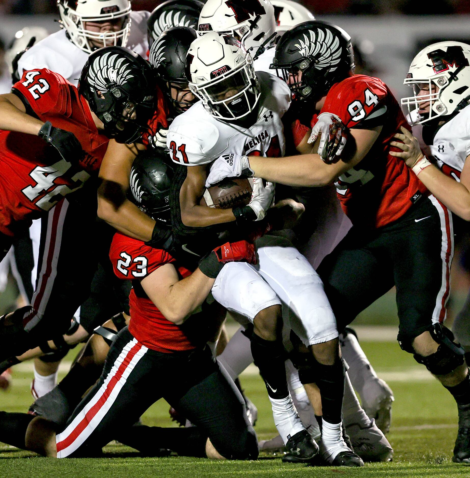 Melissa running back Nathan Adejokun (21) is stuffed by Argyle's Darian Doyle (94) and...