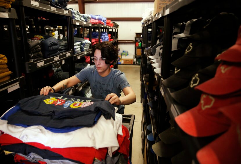 Nina Burton works on filling an order as she makes her way through aisles of merchandise...