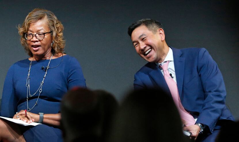 Alfreda Norman of the Federal Reserve Bank of Dallas shares a laugh with George Tang,...