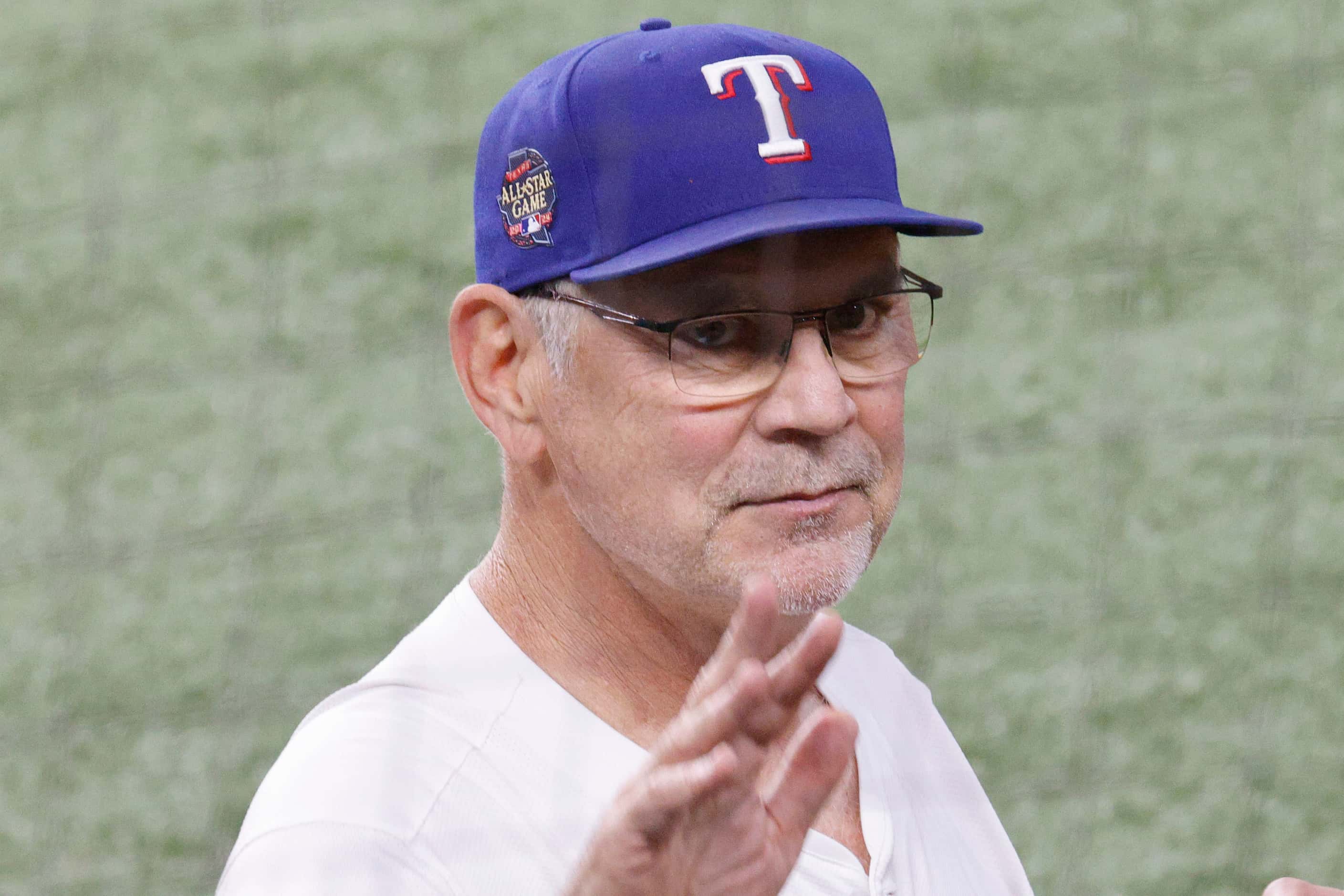 Texas Rangers manager Bruce Bochy (15) waves to fans before a baseball game against the San...