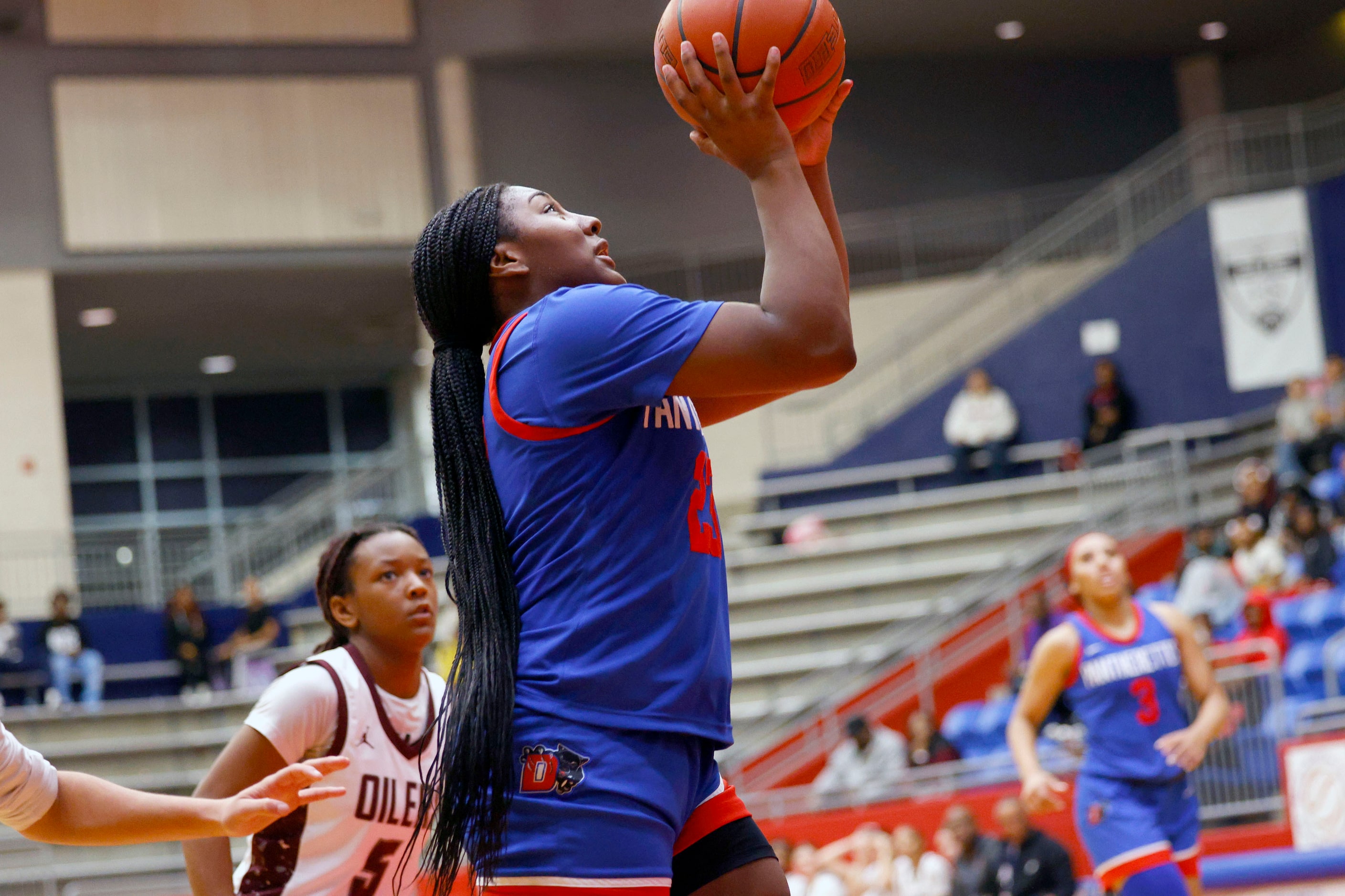 Duncanville's Trystan James (23) shoots the ball as Pearland's Tycee Thibeaux (5) looks on...