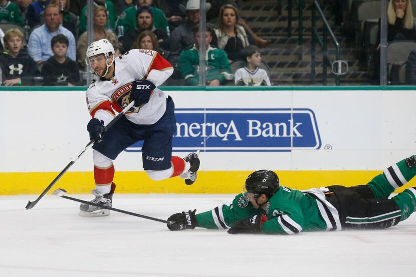 Florida Panthers center Vincent Trocheck (21) gets the puck past Dallas Stars defenseman Dan...