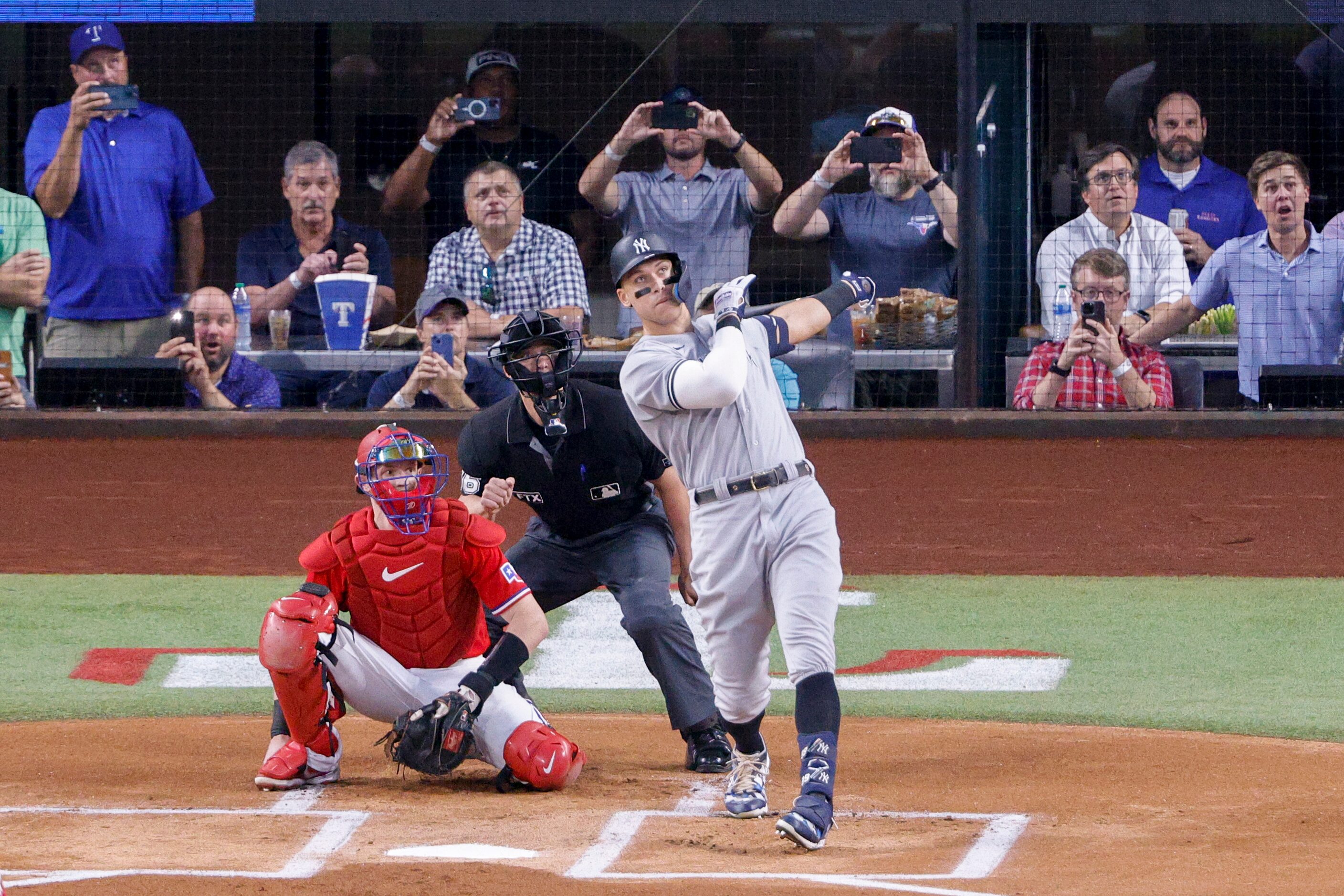 New York Yankees right fielder Aaron Judge (99) hits a home run to left field off Texas...