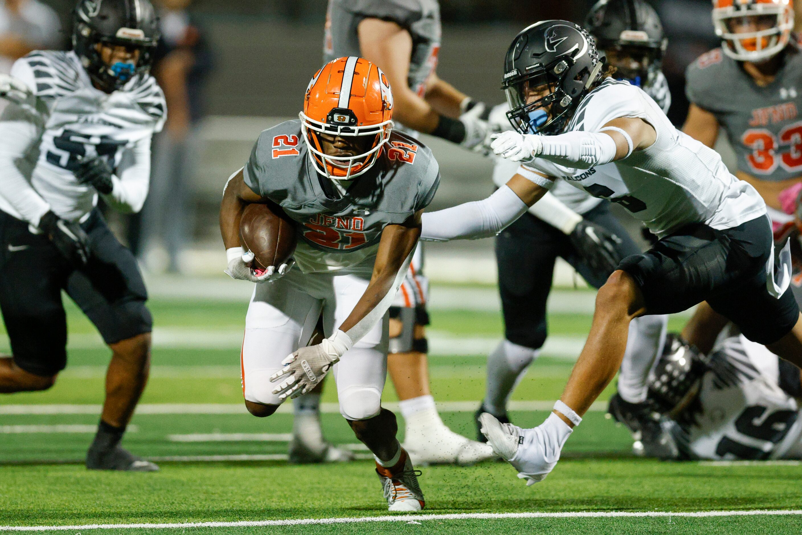 Rockwall running back Jamir Wilson (21) runs past the outstretched arms of North Forney’s...