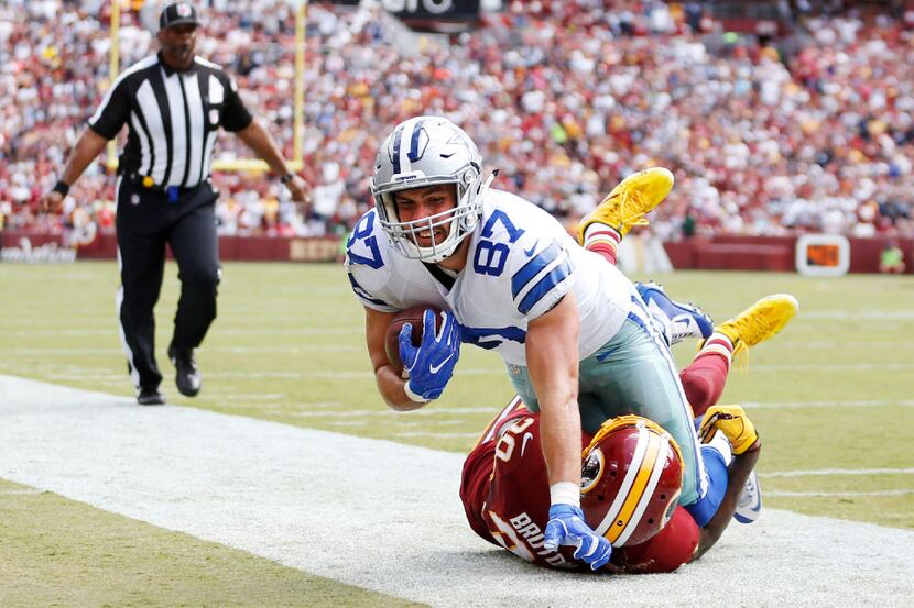 Dallas Cowboys tight end Geoff Swaim (87) is pulled out of bounds by Washington Redskins...