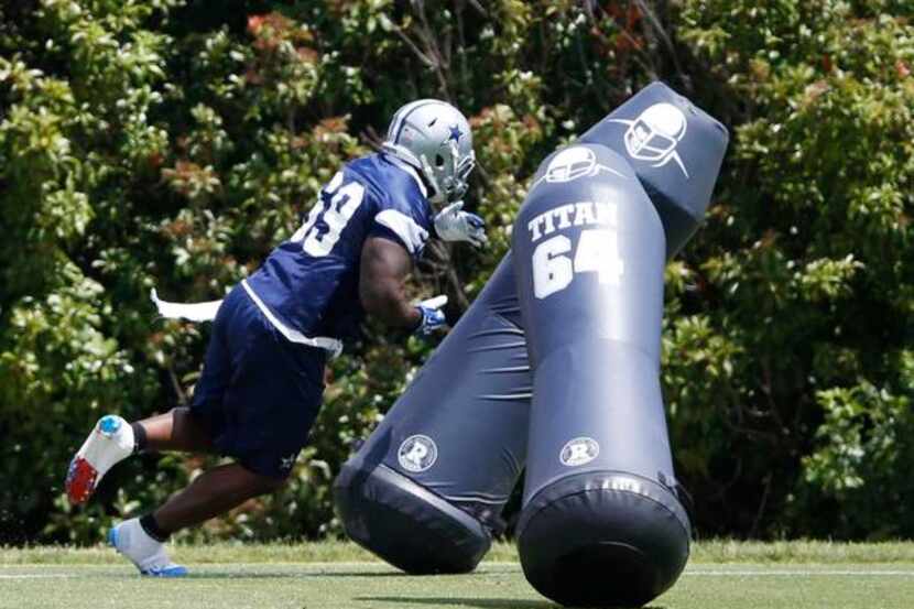 
Dallas Cowboys defensive tackle Henry Melton (69) competes in a drill during OTA's at the...