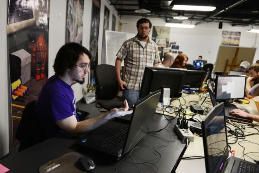 Guildhall students Jeff Listman (left) and Bryan Davenport work on their video game,...
