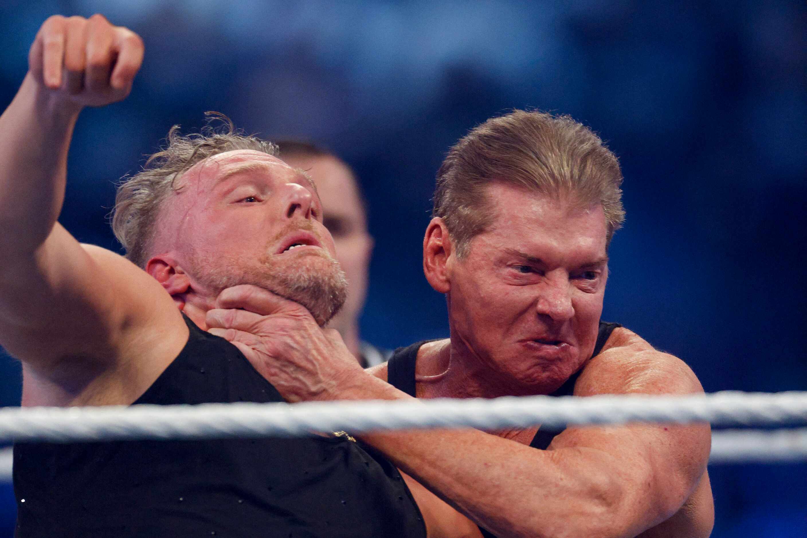 Vince McMahon (right) throws Pat McAfee into the ropes during a match at WrestleMania Sunday...