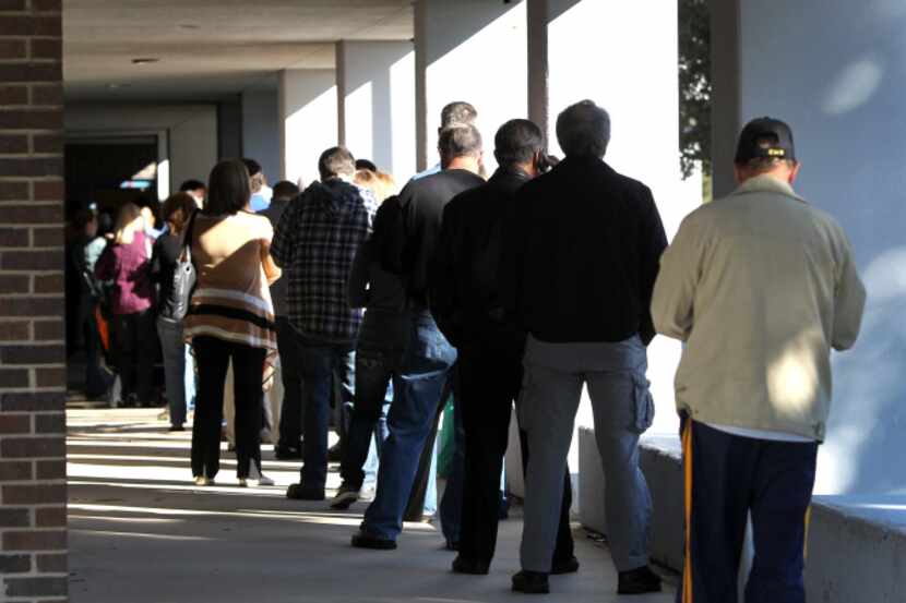 Voters stood in line as they await their turn at the polls at Kent Elementary School in...