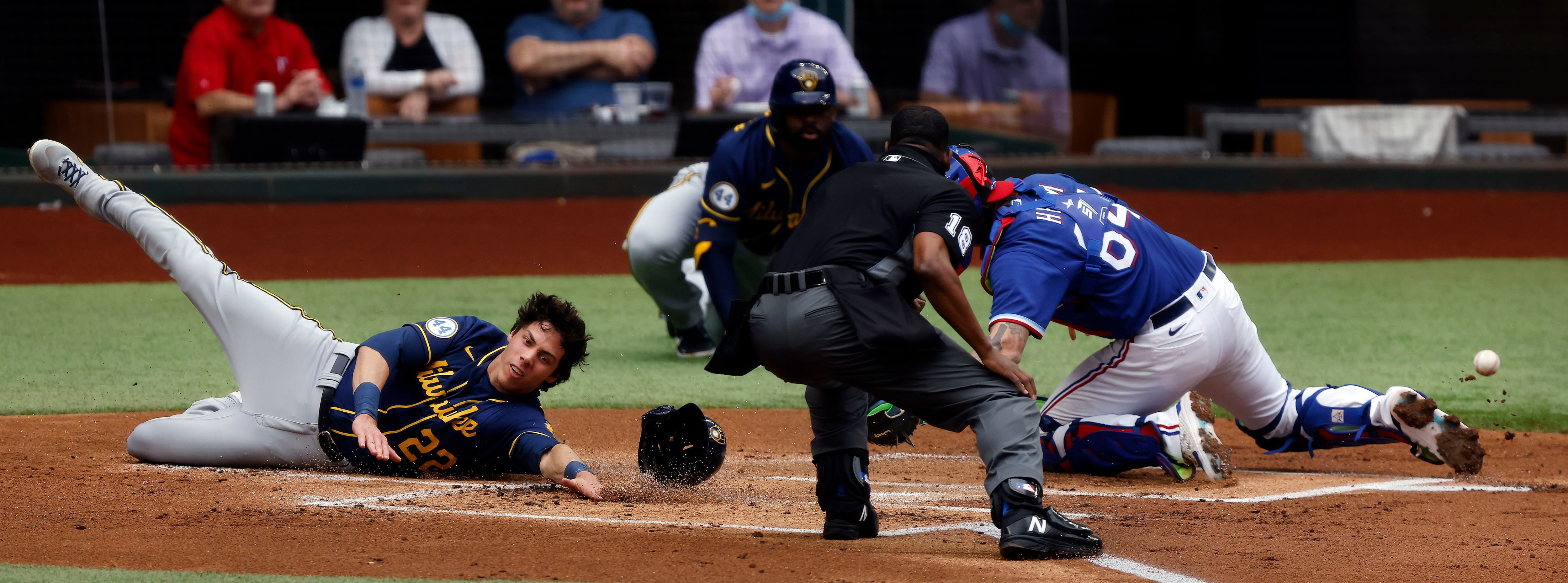 Milwaukee Brewers Christian Yelich (22) slides safely into home plate as Texas Rangers...