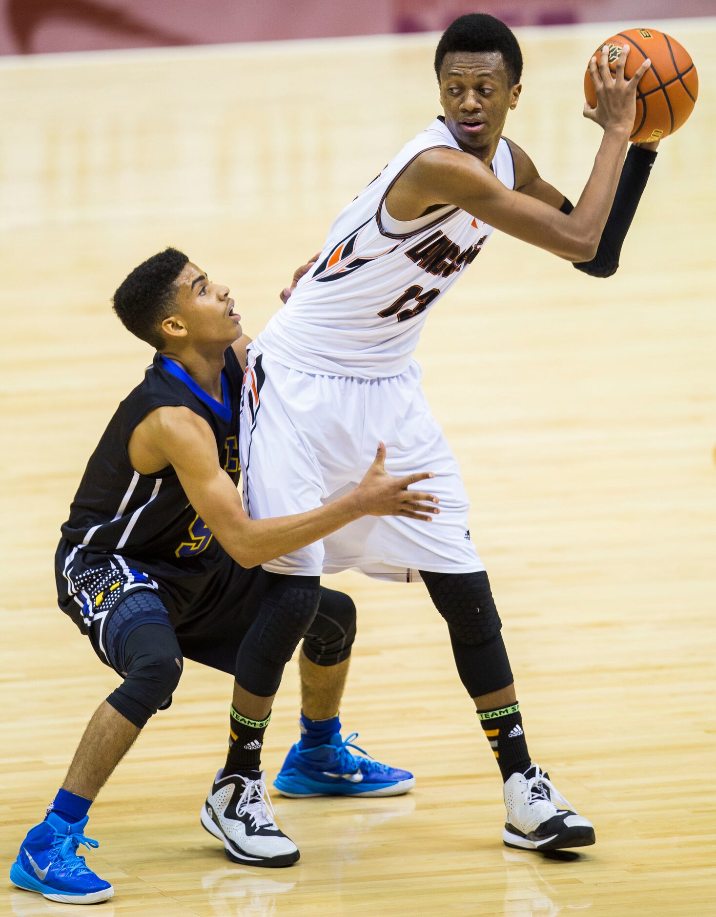 Lancaster guard Antwon Portley (13) keeps the ball away from Beaumont Ozen guard Jalen Sneed...