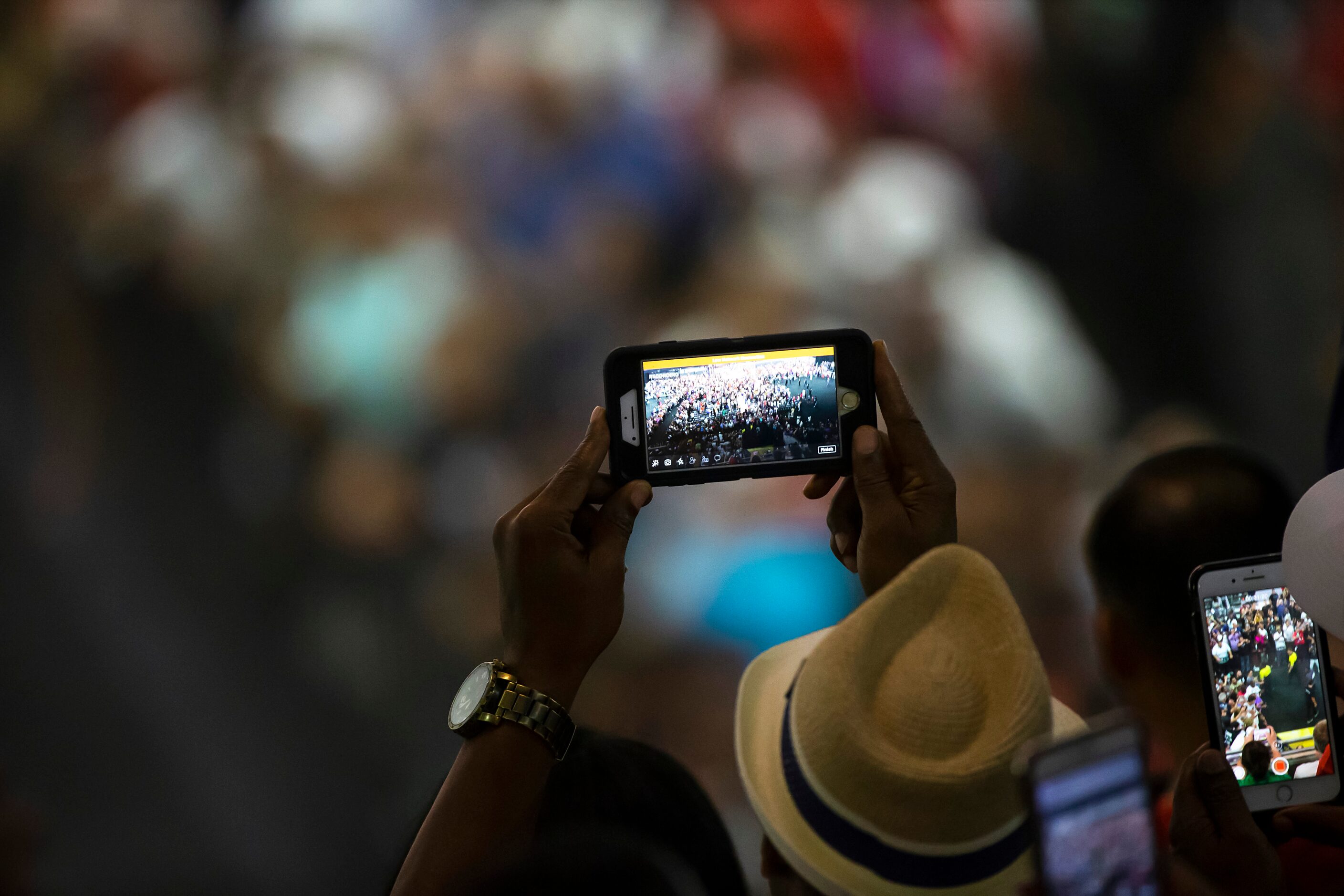 Fans take photos as welterweight champion Errol Spence Jr. enters the ring to defend his IBF...