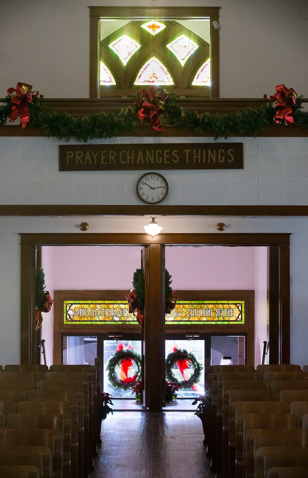 The sign "Prayer Changes Things," which used to hang near the baptistery behind the pulpit,...