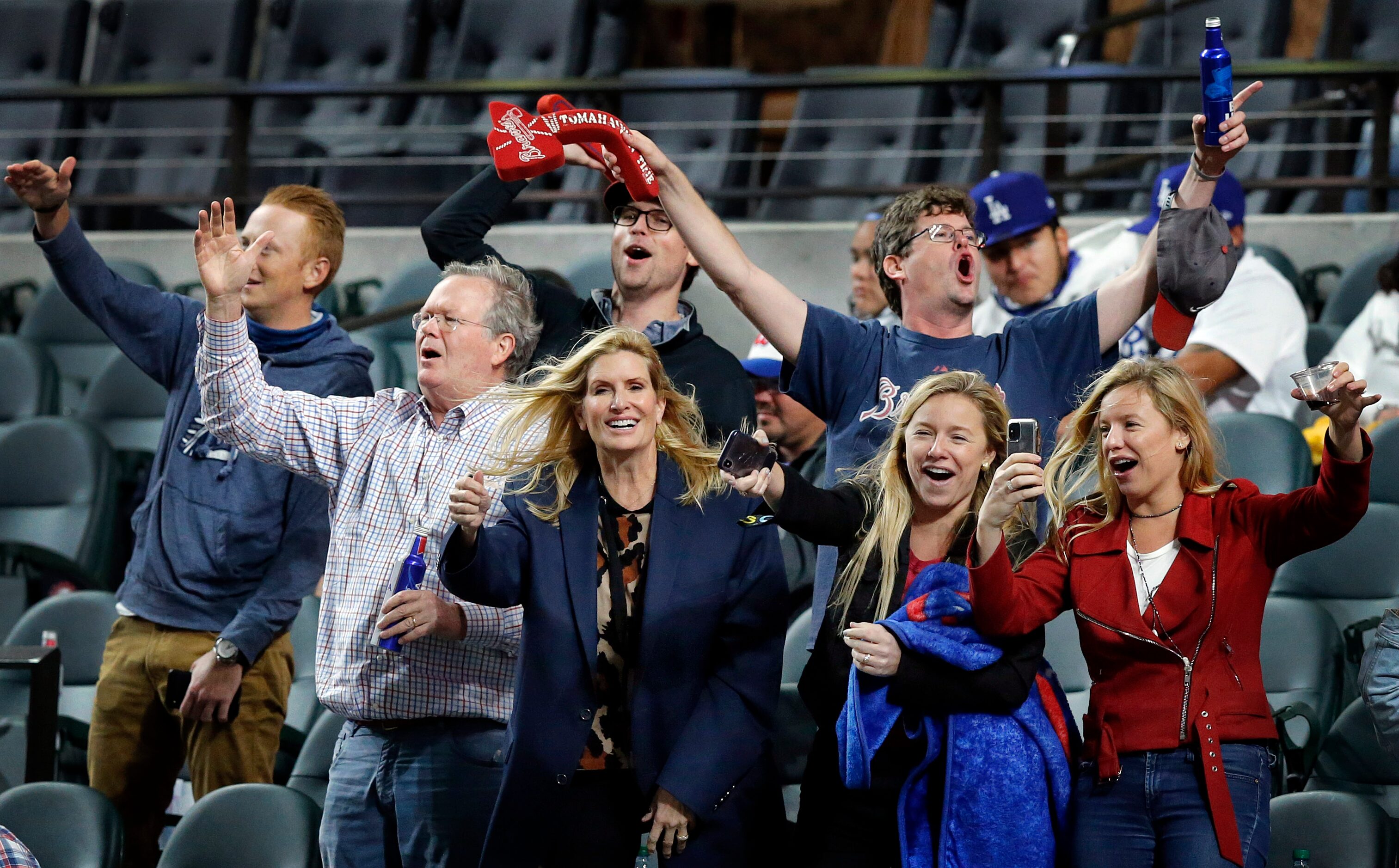 Atlanta Braves fans dance in their seats during the sixth inning in Game 4 of the National...