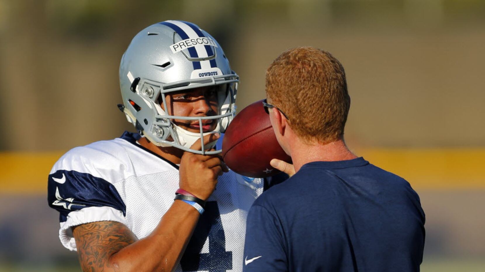 Dallas Cowboys quarterback Dak Prescott (4) listens to head coach Jason Garrett before they...