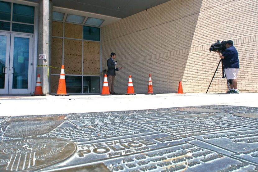  Boarded up windows beside the entrance to the Jack Evans Police Headquarters on S. Lamar...