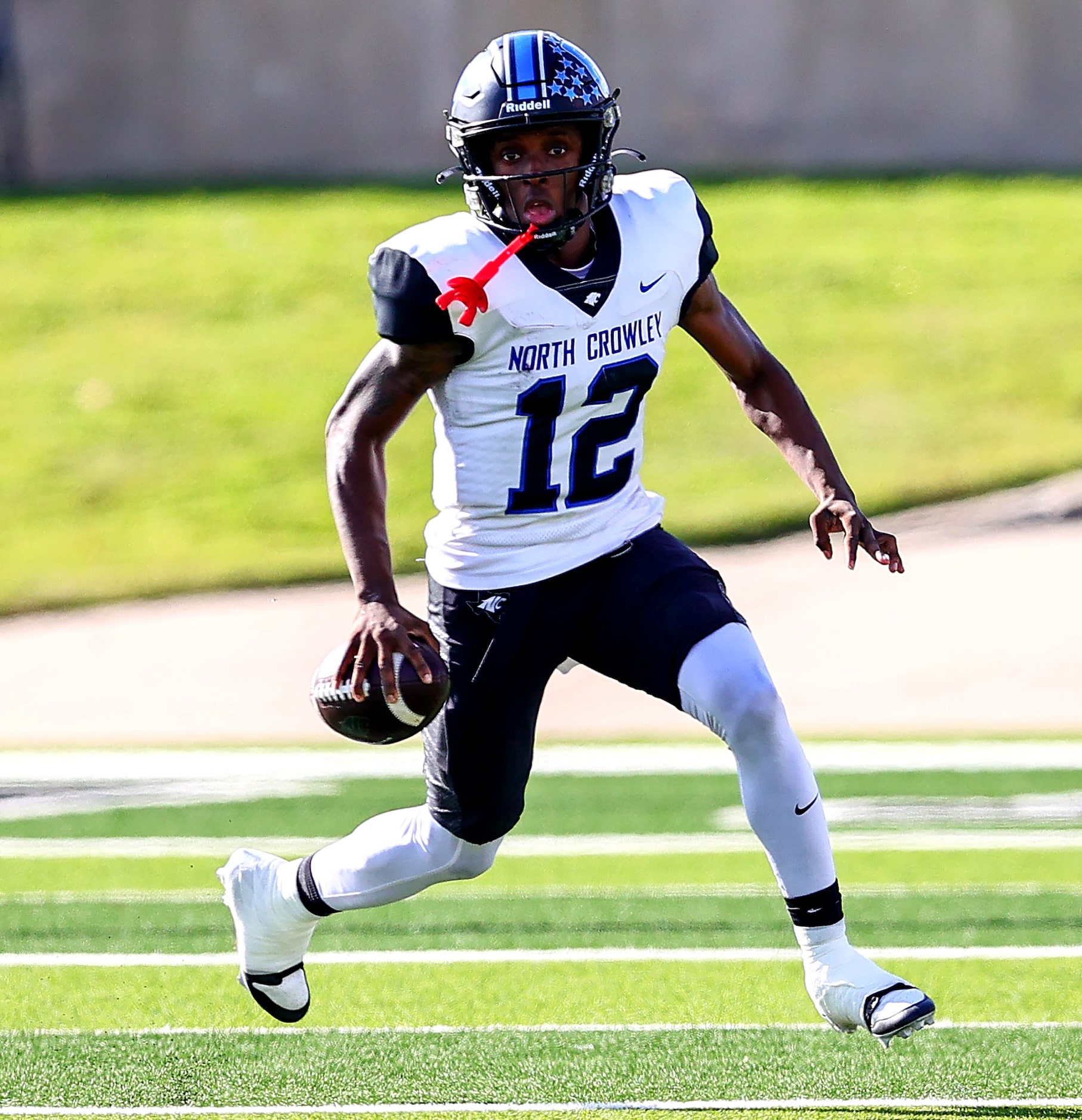 North Crowley quarterback Chris Jimerson Jr (12) rolls out to pass against Allen during the...