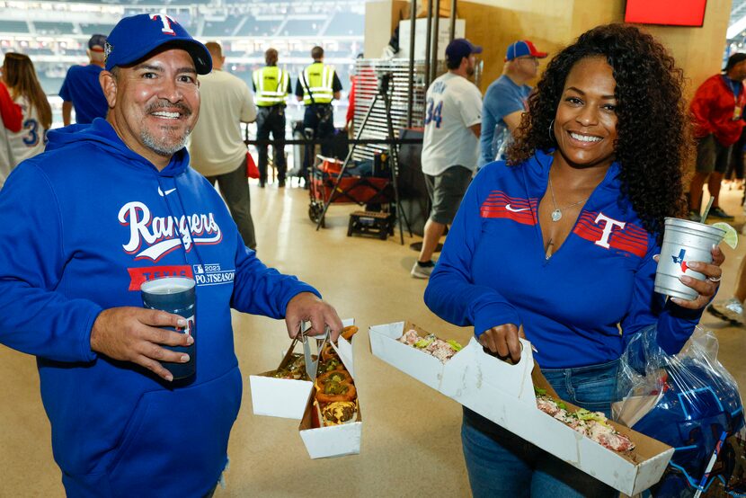 Tamara Palmer (right) and Paul Morales of Arlington pose for a photo with a $250 set of...