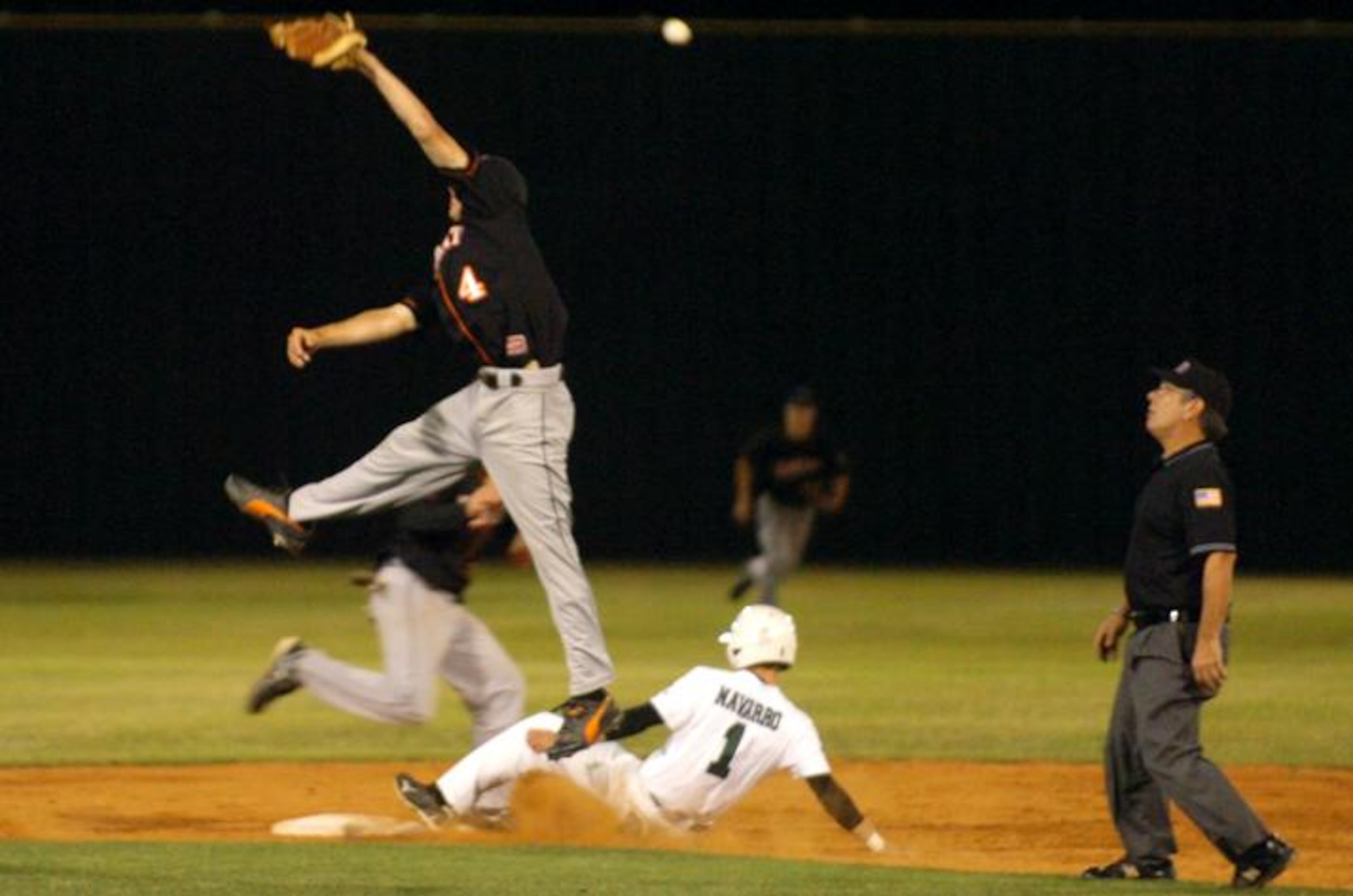 Lake Dallas' Ryan Navarro (1) slides into second as Aledo's Austin Lawler (4) leaps after a...