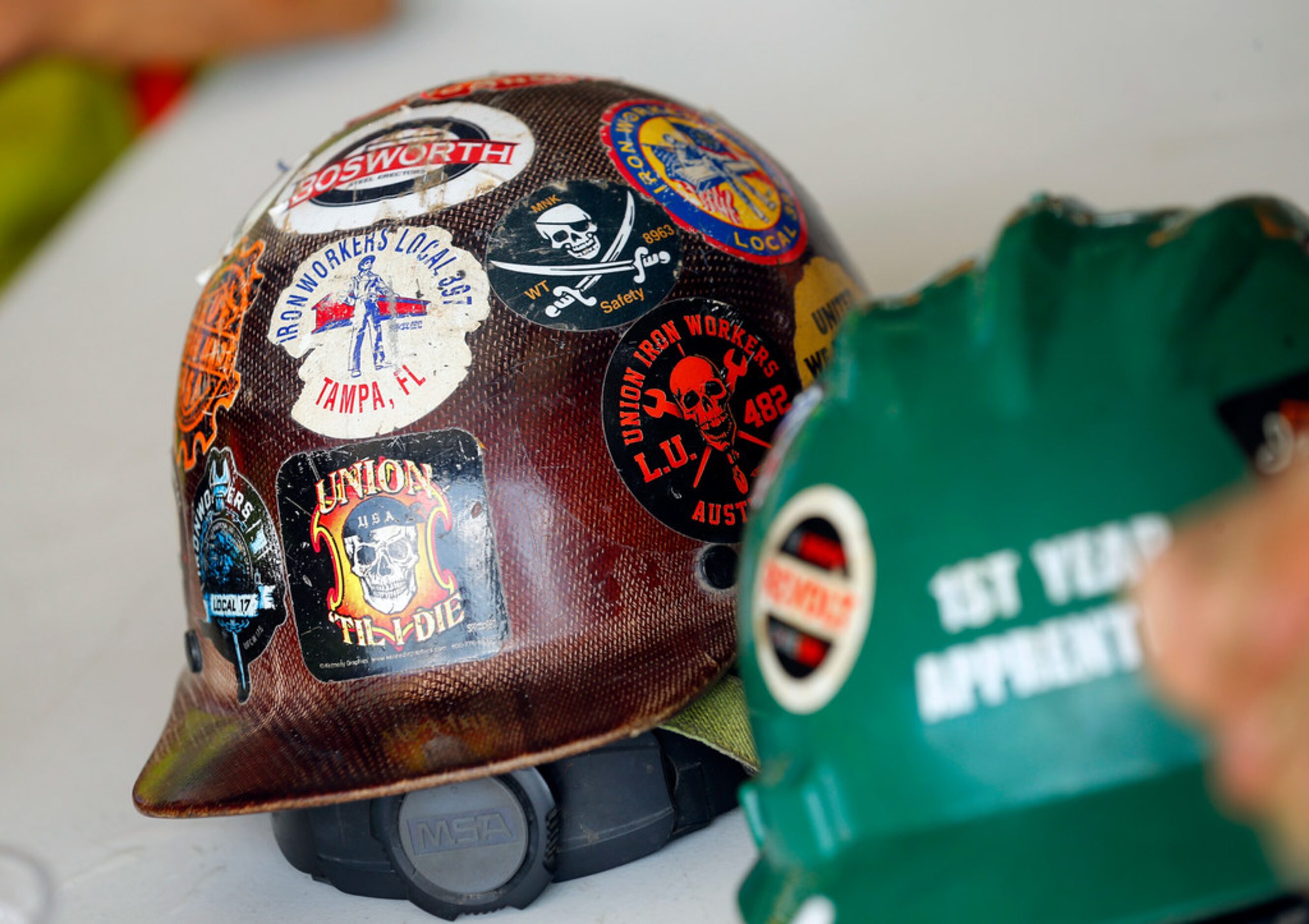 Workers removed their construction helmets to eat a catered lunch at the new Globe Life...