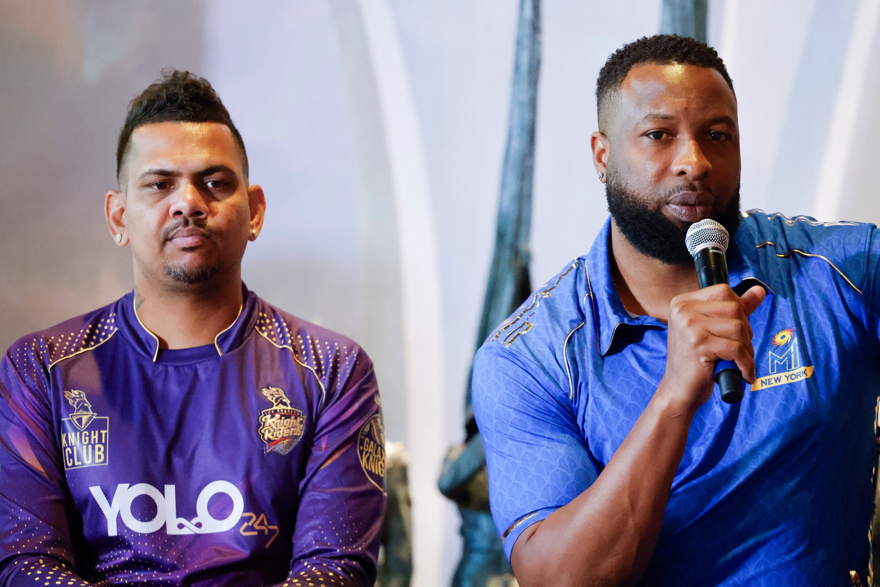 Los Angeles Knight Riders Sunil Narine (left), listens to MI New York’s captain Kieron...