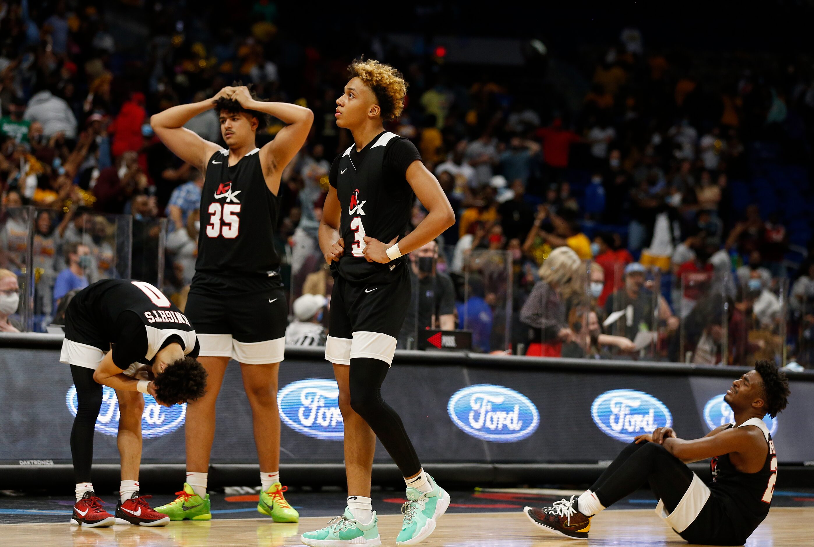 Kimbal players react after losing in OT to Beaumont. UIL boys Class 5A basketball state...