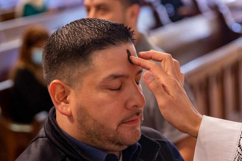 Santos Martinez, communications specialist for the Catholic Diocese of Dallas, receives...